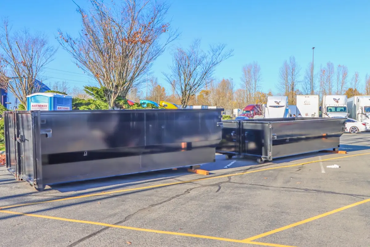 Professional dumpster rental service with roll-off container on residential driveway in Eden Isle